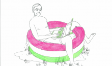 Nicholas Negroponte with an OLPC laptop in a paddling pool
